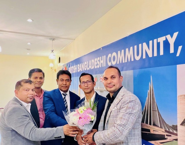 Receiving floral greetings as a publisher on behalf of the British-Bangladeshi community.